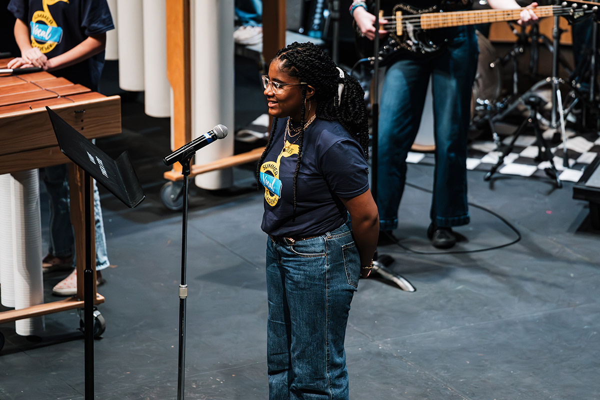 A vocalist performing a solo into the microphone