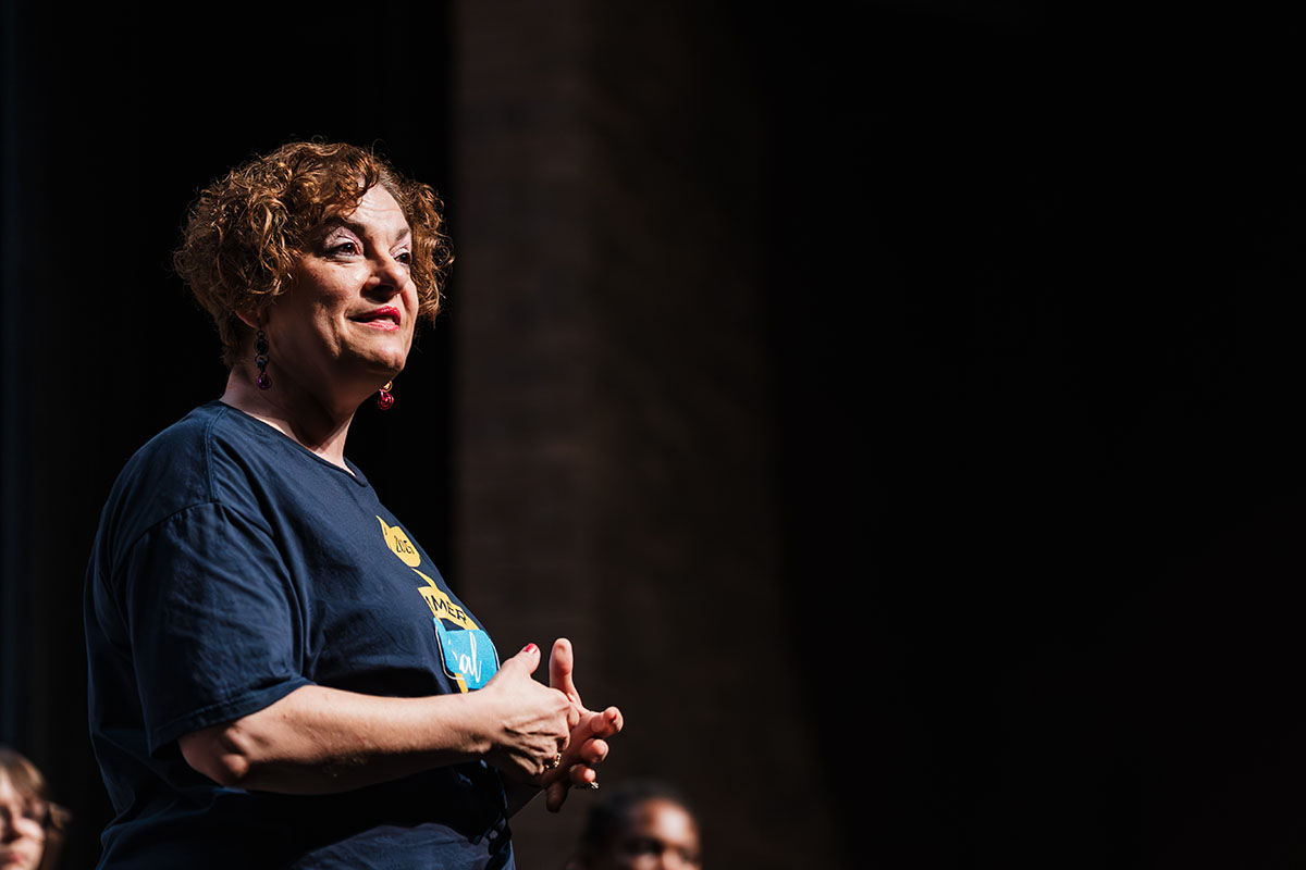 An instructor addressing the audience during the Summer Vocal Academy of Music.