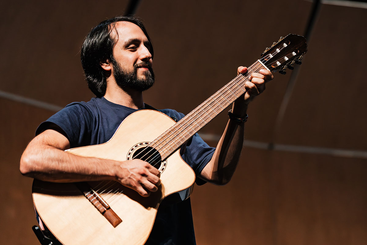 A man playing guitar on stage.