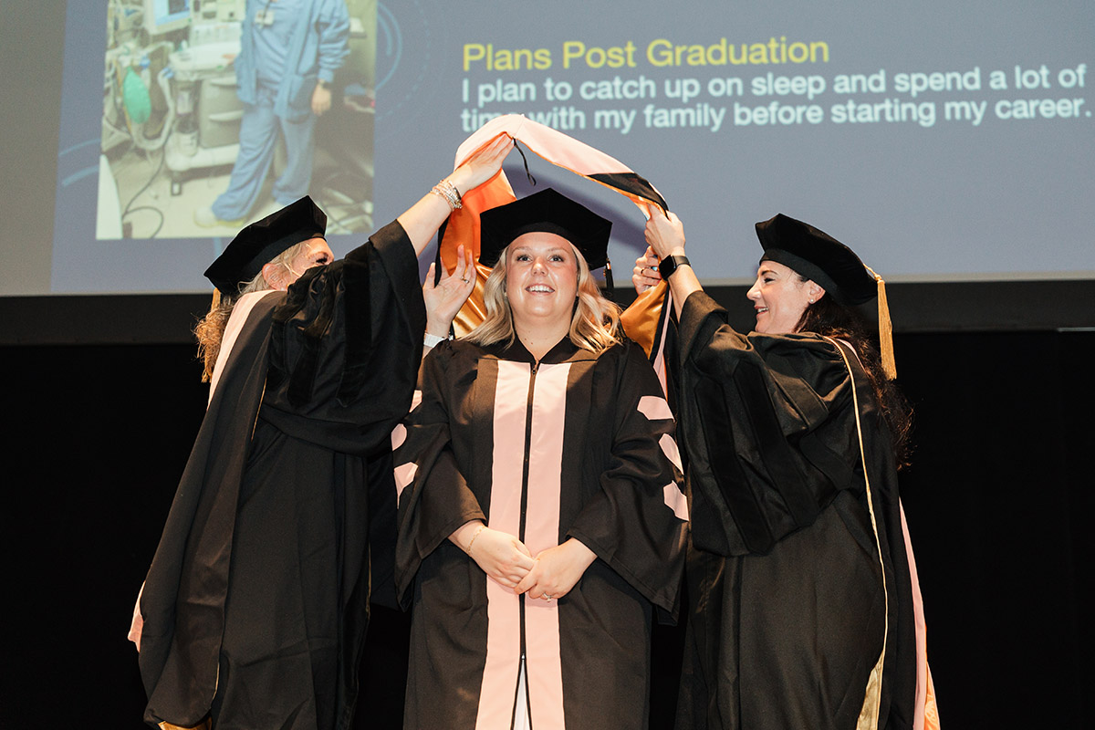 A female DNAP graduate receiving her stole