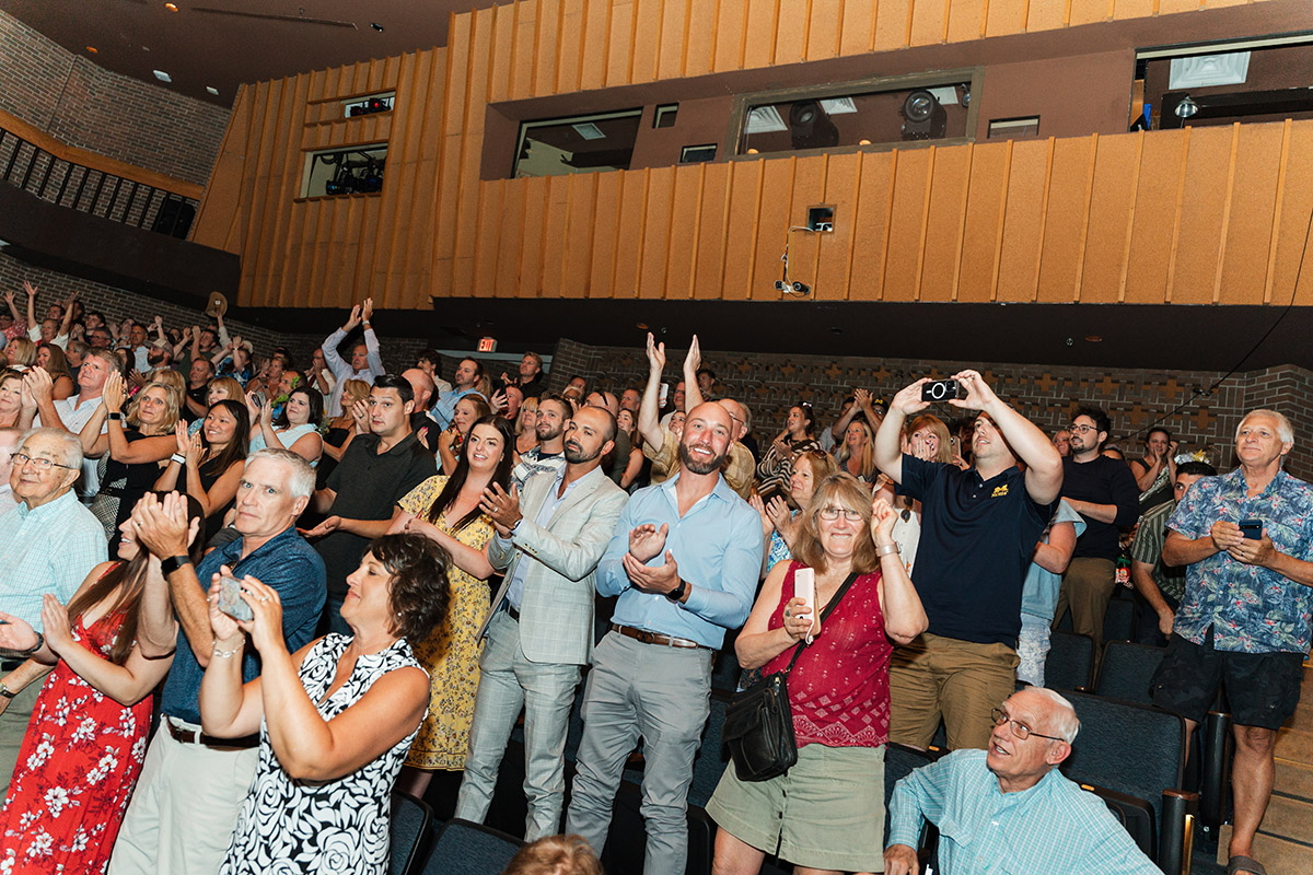 A view of the crowd in the UM-Flint Theatre on their feet applauding.