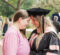 A female dnap graduate touching foreheads with a member of her family