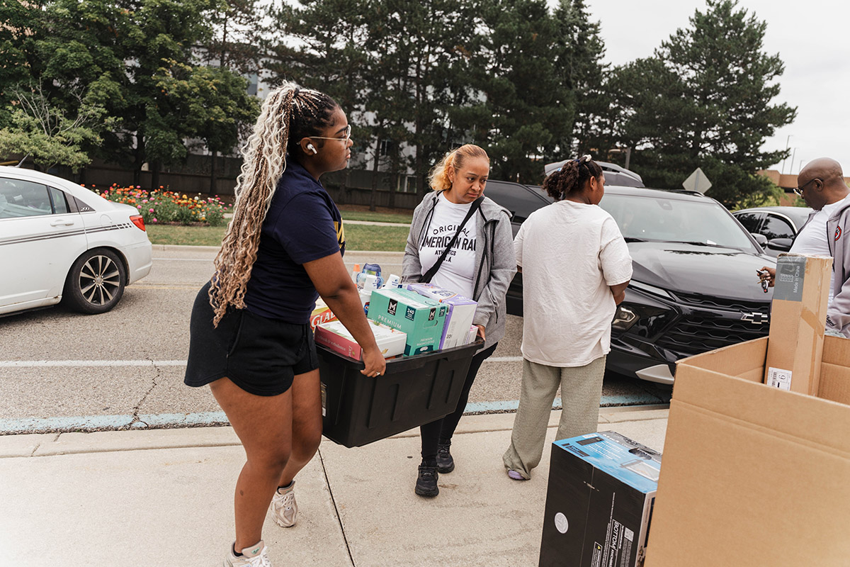 UM-Flint students carrying a tote