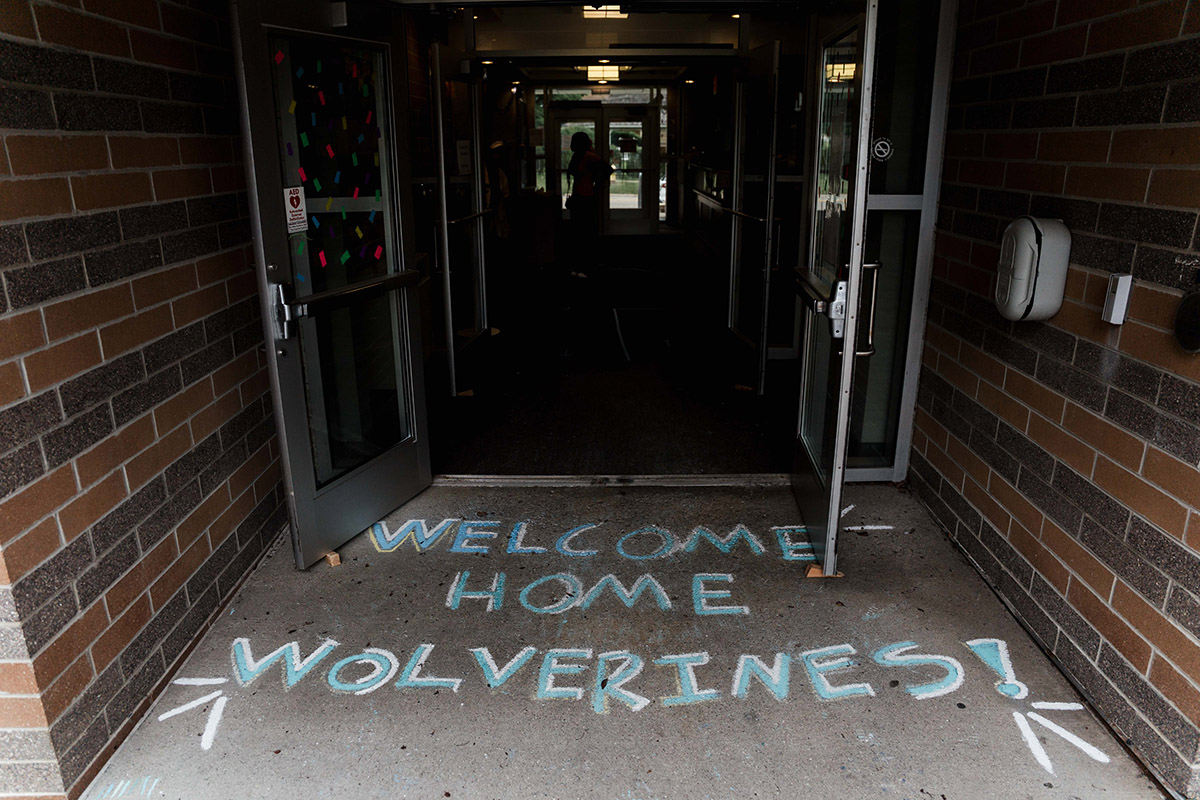 Chalk on the pavement that says Welcome Home Wolverines