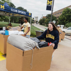 UM-Flint students carting their belongings inside.