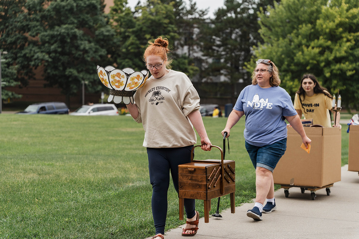 A family and student volunteers help brings items insdie