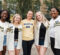 A group of Move-in Volunteers in Maize and Blue Baseball jerseys in front of First Street Residence Hall
