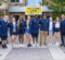 Students and staff stand in front of First Street Residence Hall during move-in.