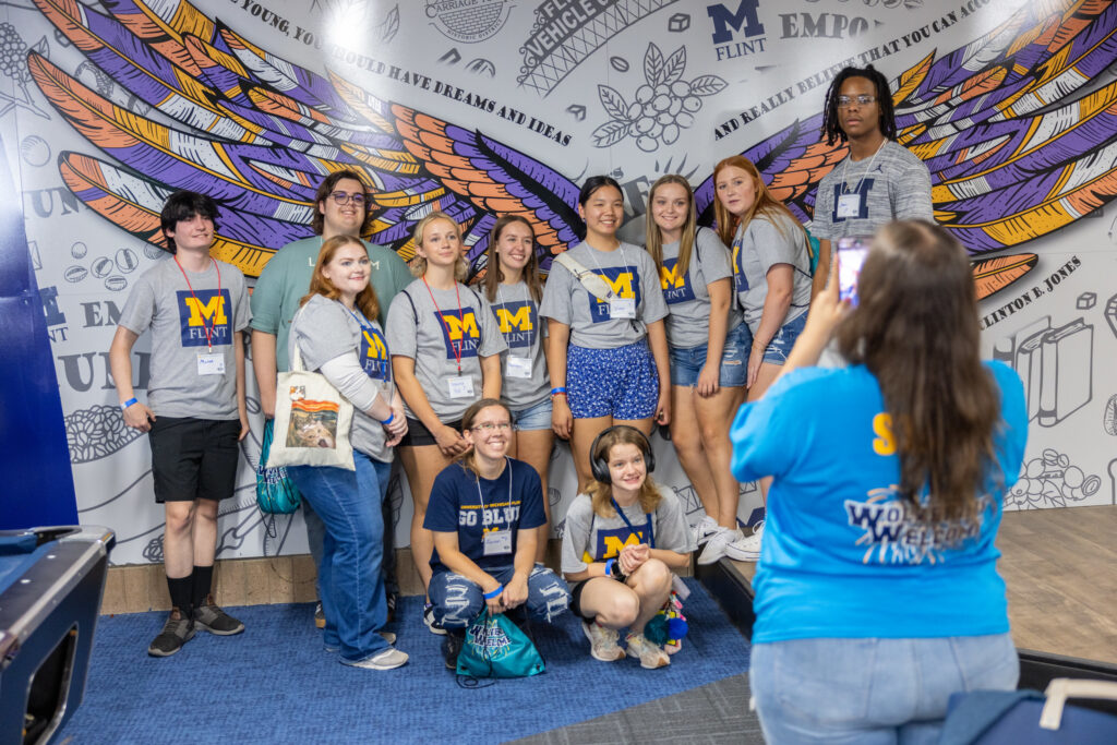New students pose with a campus mural during last year's Wolverine Welcome.