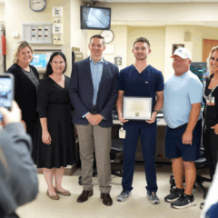 A group of people posing for a photograph in a hospital setting.
