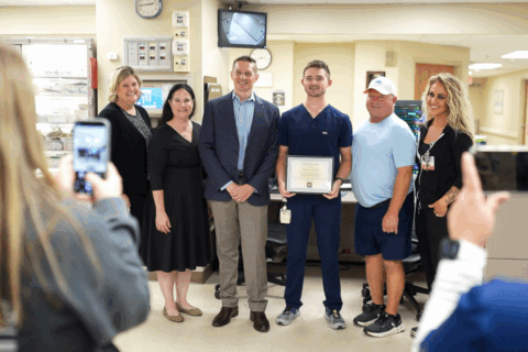 A group of people posing for a photograph in a hospital setting.