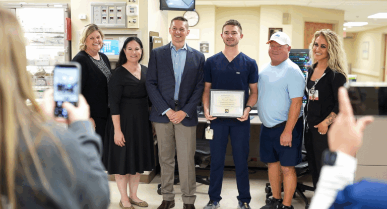 A group of people posing for a photograph in a hospital setting.