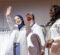 A UM-Fint physician assistant student receiving her white coat on stage from a UM-Flint faculty member.