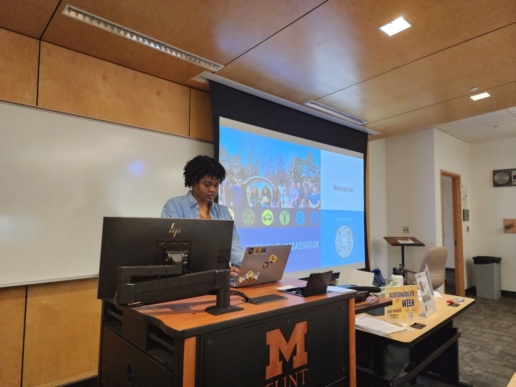Cathey presents during a specialized group training session. She stands at a computer while she pulls up a power point presentation. 