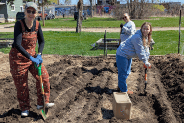 Volunteers help at the Edible Flint garden on Earth Day.