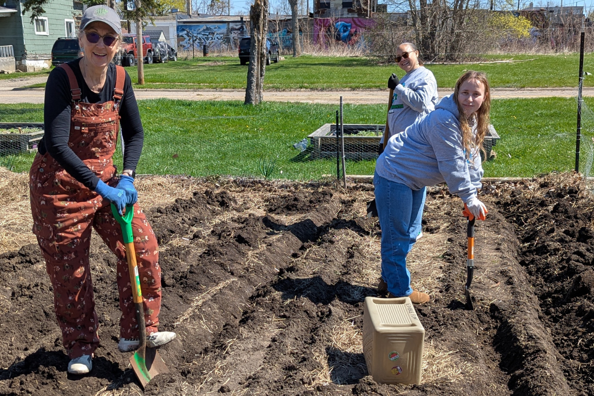Volunteers help at the Edible Flint garden on Earth Day.