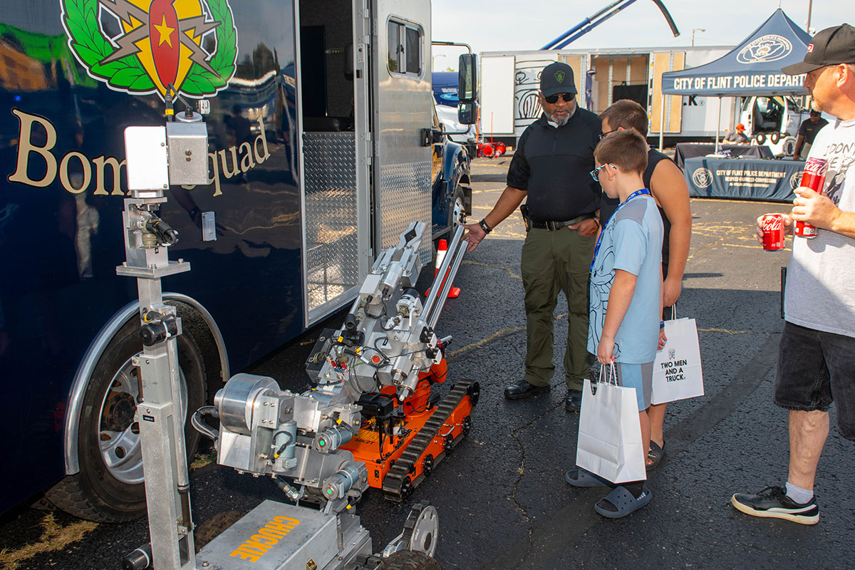 A Touch a Truck attendee looking at Flint PD's remote bomb disposal robot