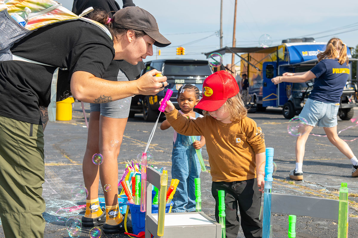 A family playing with bubbles at Touch a Truck