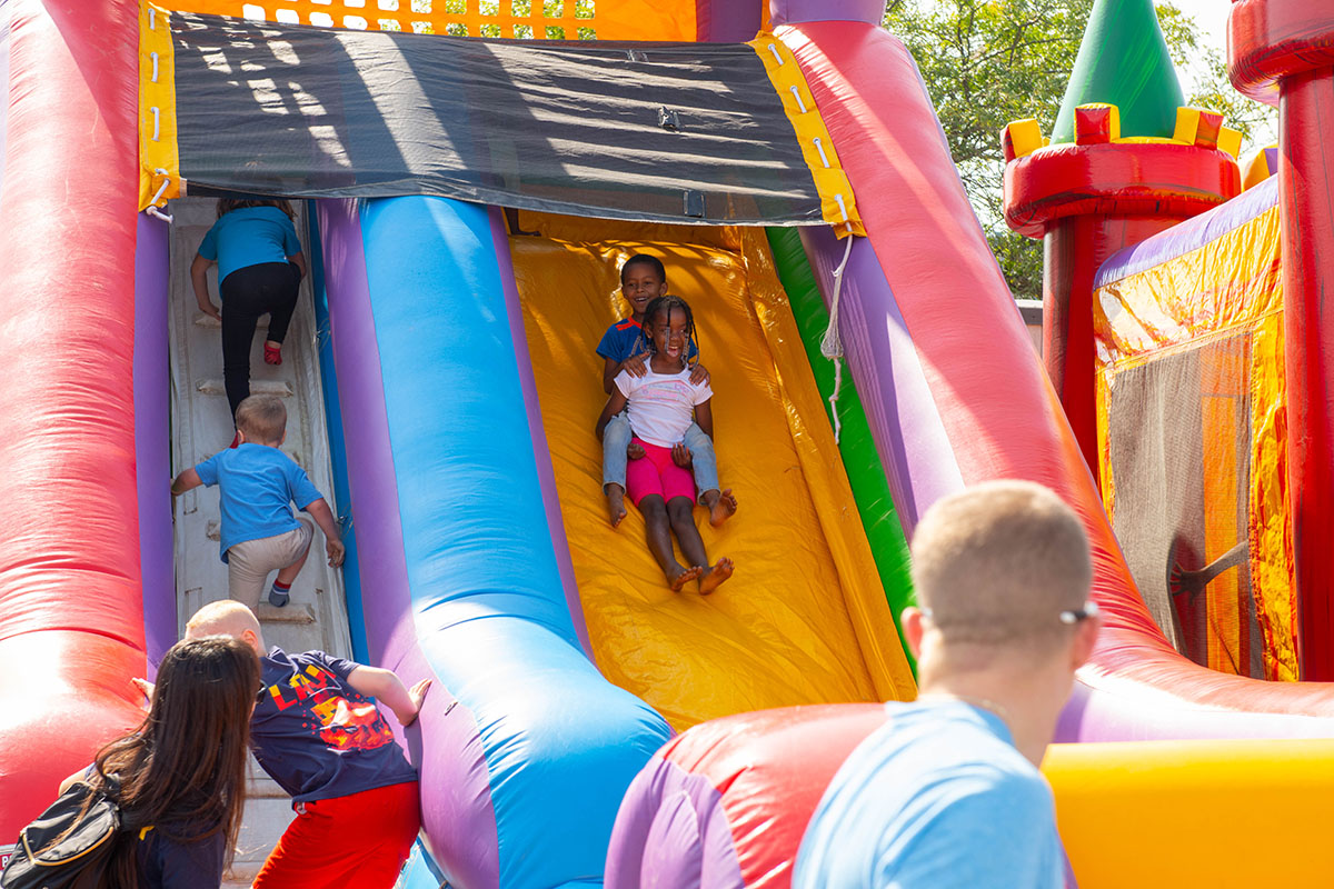 Children sliding down an inflatable slide.