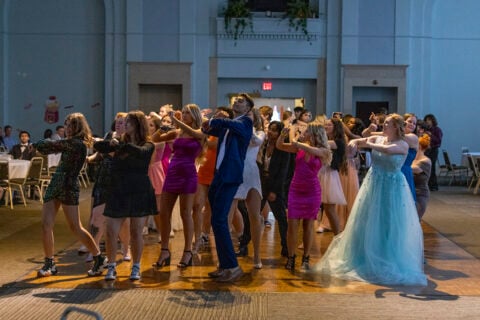 Students in formal wear dancing on the dance floor of the Northbank Ball ROom