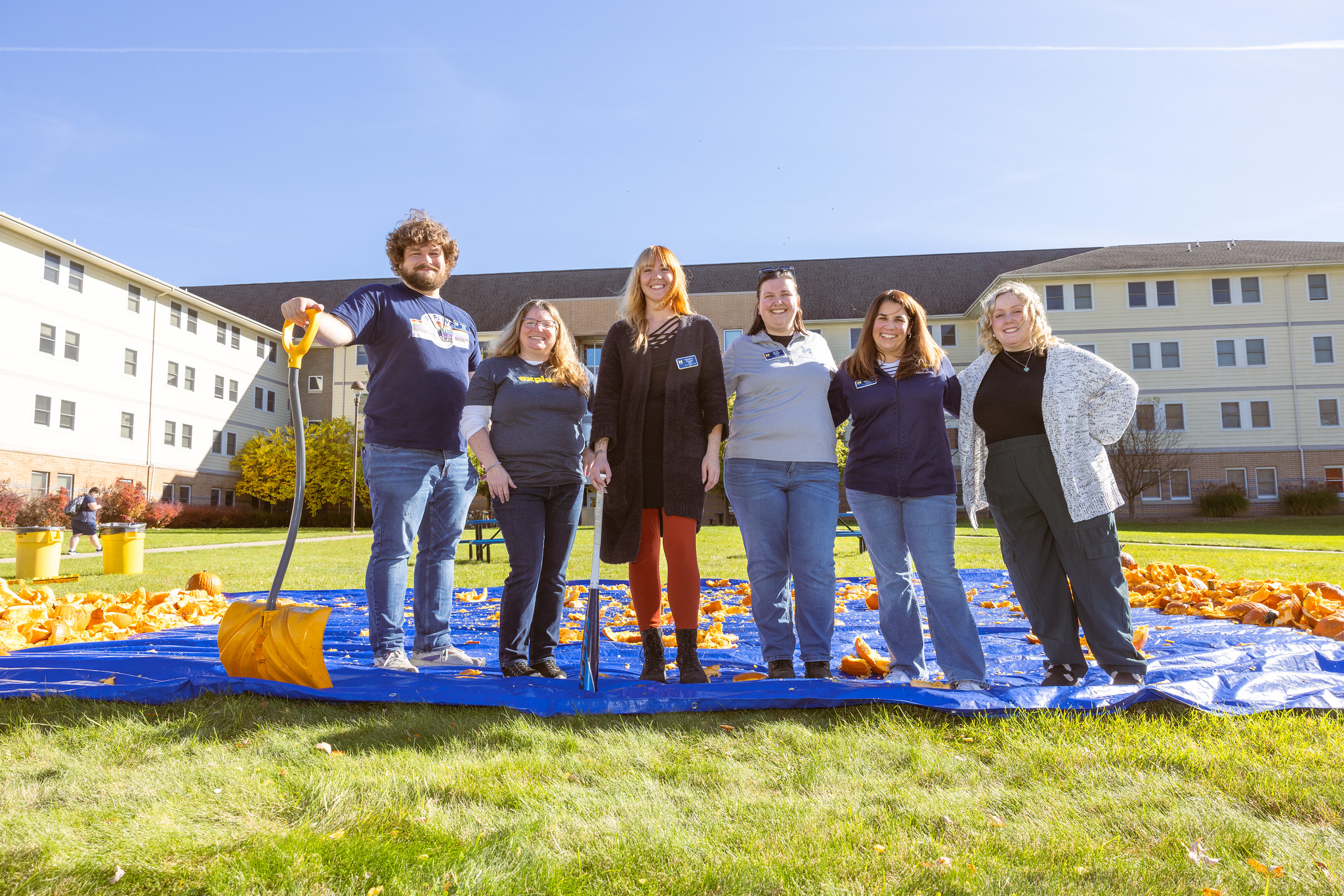 A group photo of staff members from the CAPS office. Standing in on First Street lawn during their annual smashing pumpkins event. 