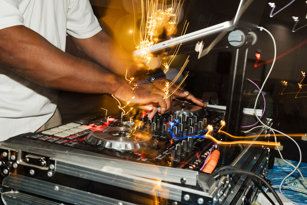 A close up of a DJ's hands working a mixtable.