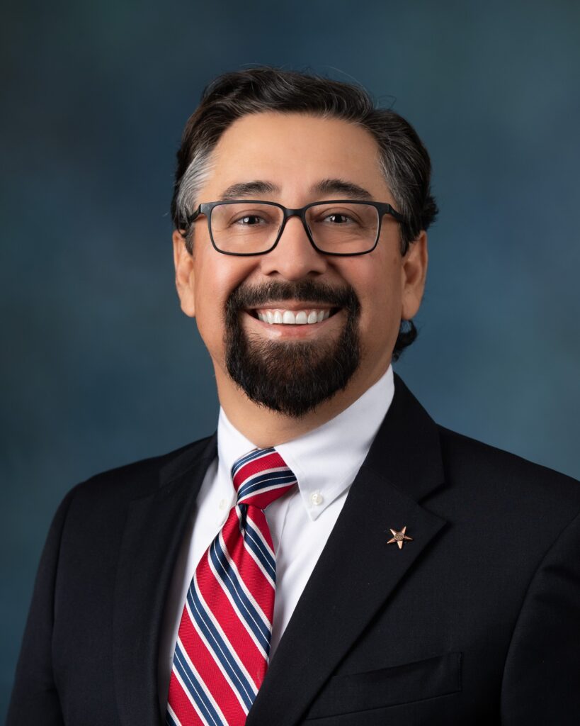 John Juarez wearing a suit and tie