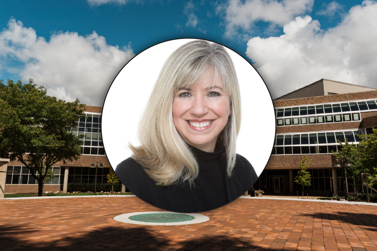 A circular portrait of a woman with long, blonde hair, set against a background of a modern building and blue sky.