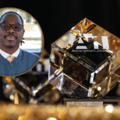 A crystal award with the text "the ATI of Achievement Awards" and "Certified Tourism Ambassador" displayed prominently. Antonio Riggs' photo is overlaid.