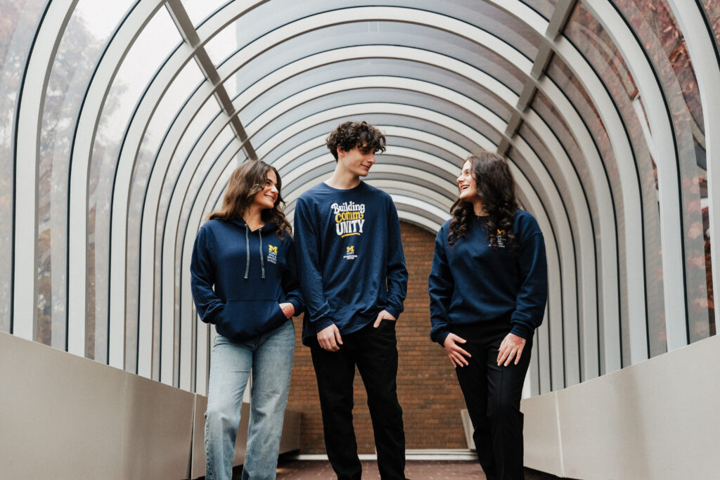 The Jarbou siblings walking in a skywalk on campus