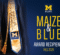 Graduation stoles with "MAIZE & BLUE" and "SCHOLAR" text, representing award recipients for Fall 2025 at the University of Michigan-Flint.