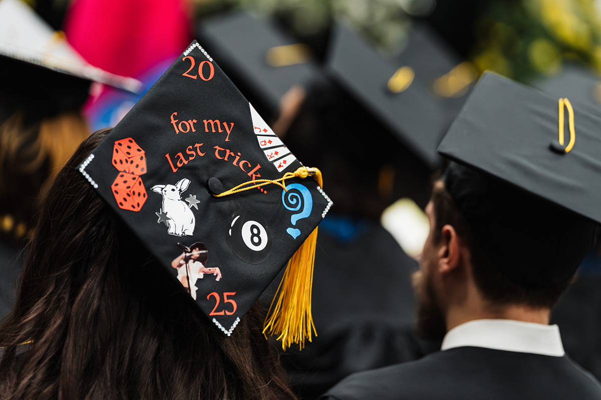 A graduation cap decorated with the text "20 for my last trick..." along with images of dice, a rabbit, and an eight ball, with the year "25" at the bottom.