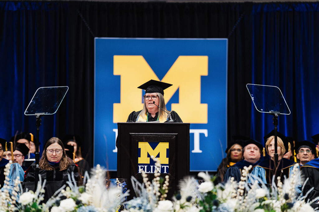 Angela Diemer speaking at the commencement podium
