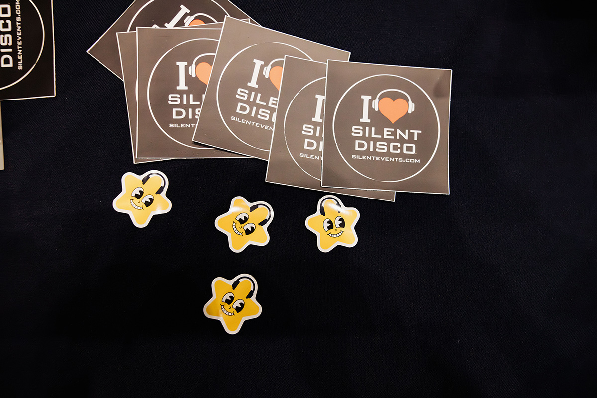 A collection of stickers featuring the text "I ❤️ SILENT DISCO" and a website, along with several yellow star-shaped stickers with smiling faces.