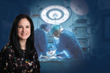 A person with long black hair wearing a floral blouse is positioned in the foreground, while two medical professionals in scrubs are performing surgery in the background.