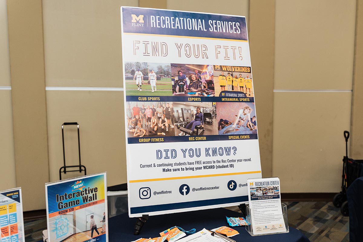 Poster for University of Michigan Flint Recreational Services promoting club sports, esports, intramural sports, group fitness, rec center, and special events with social media handles.