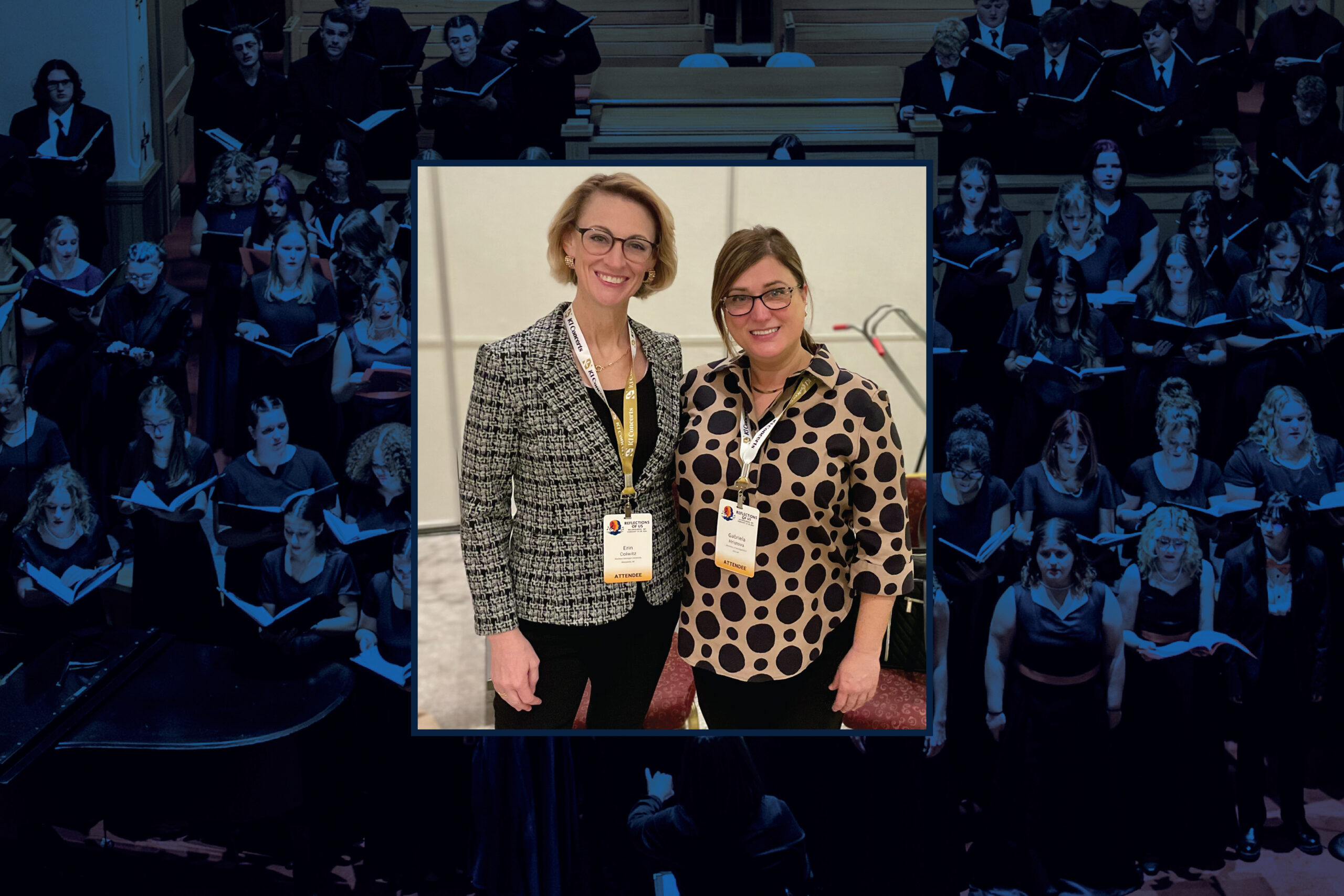 Two women wearing conference badges stand side by side indoors. The background is a choral performance.