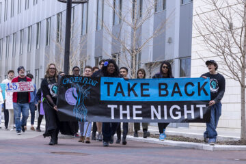 Students march with a sign that read Take Back the Night.