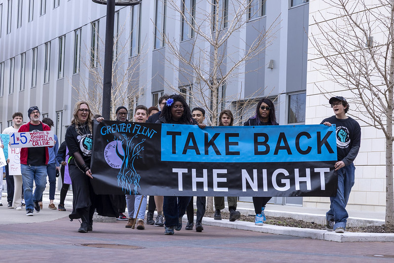 Students march with a sign that read Take Back the Night.
