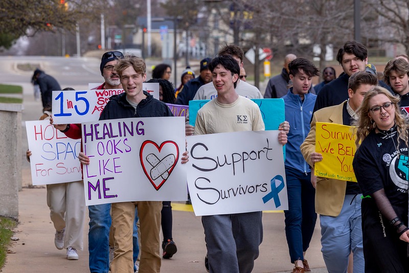 Students march with signs.