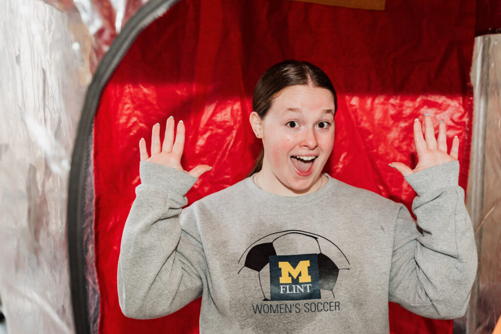 Abigail Weycker smiling for the camera inside the Cash Cube.