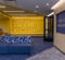 Interior of the James C. Renick University Center featuring a large yellow wall with the text "HAIL TO THE VICTORS" and a blue seating area with patterned cushions.