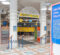 Entrance to the University Pavilion featuring a sign that reads "UNIVERSITY PAVILION," colorful hanging lanterns, and informational displays about UM-Flint and the city of Flint.