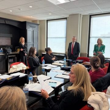 Carman Turkelson, professor of nursing, watches as attorneys Sara Kennedy Coaster and Timothy Turkelson instruct SANE students about proceedings in a mock trial environment.
