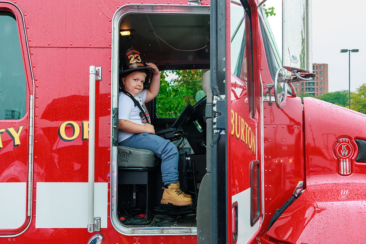 FLINT_TOUCH A TRUCK 2026_0007 Attendees explore emergency and service vehicles during the University of Michigan-Flint Department of Public Safety Touch-a-Truck event.