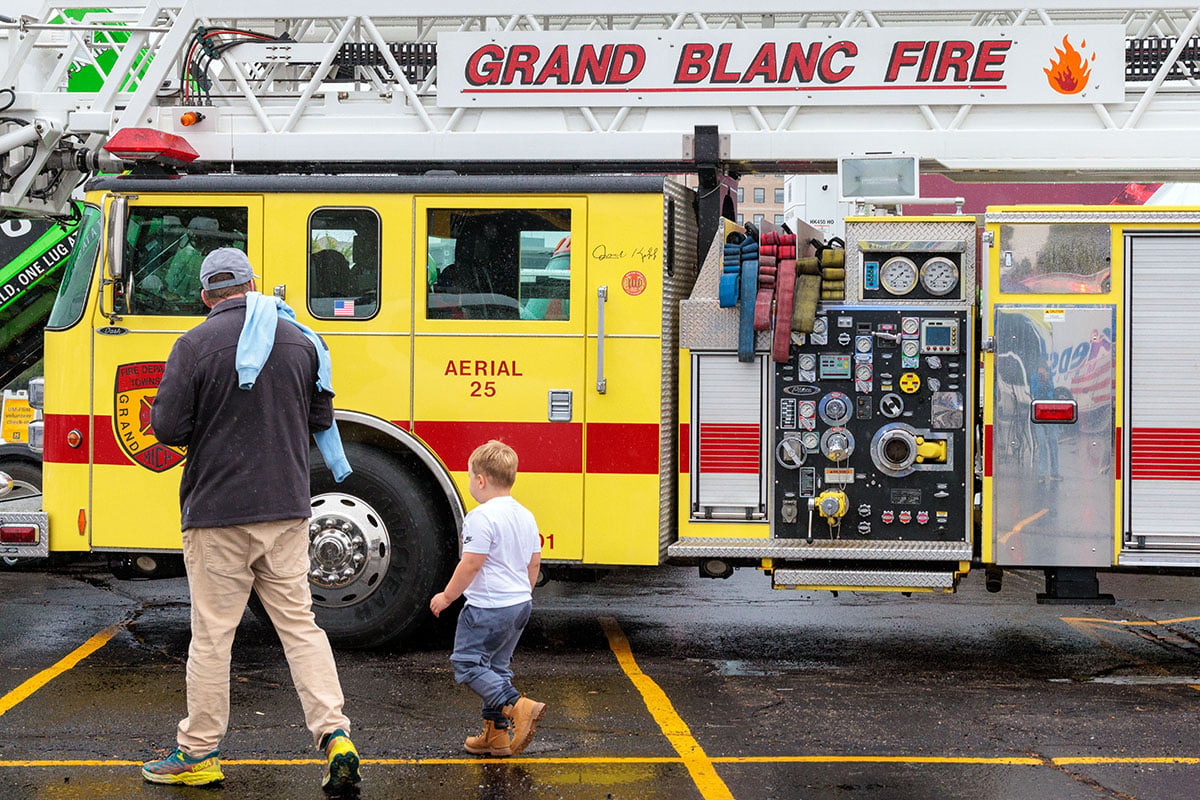FLINT_TOUCH A TRUCK 2026_0012 Attendees explore emergency and service vehicles during the University of Michigan-Flint Department of Public Safety Touch-a-Truck event.
