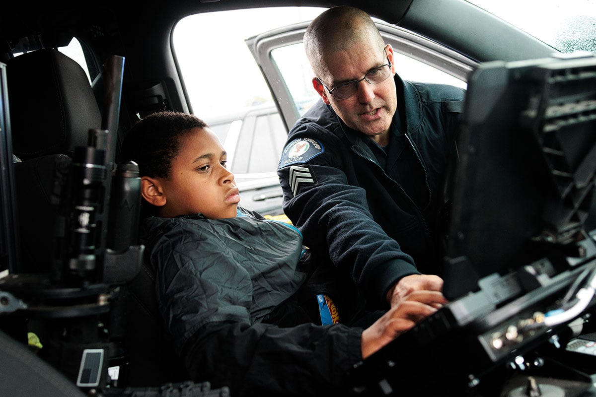 FLINT_TOUCH A TRUCK 2026_0022 Attendees explore emergency and service vehicles during the University of Michigan-Flint Department of Public Safety Touch-a-Truck event.