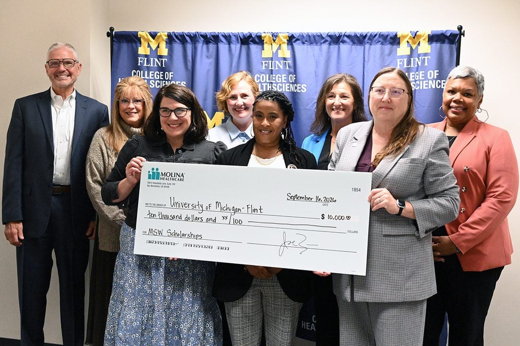 Tasheikya Hunter surrounded by UM-Flint College of Health Sciences and Molina Healthcare administrators.